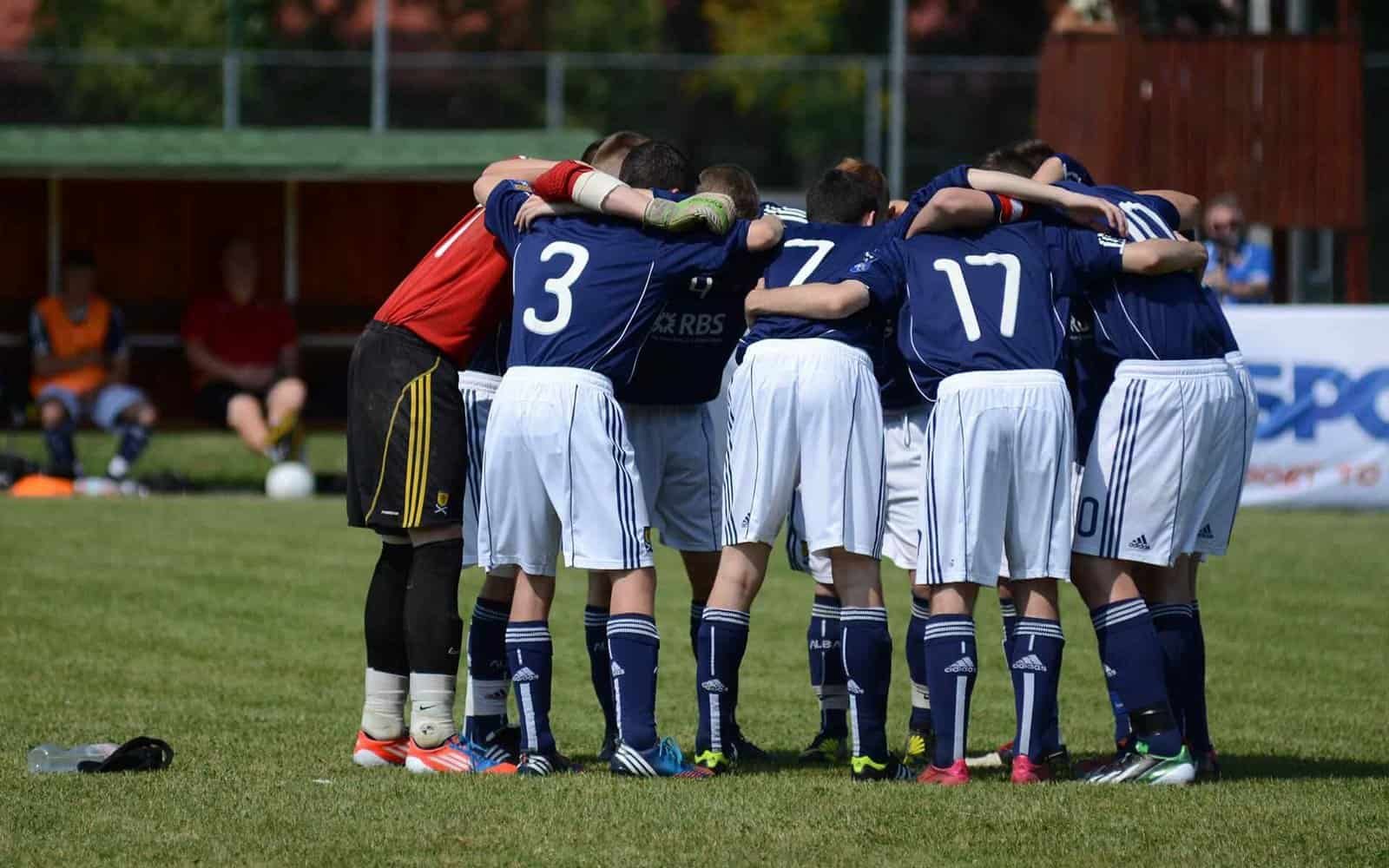Young soccer team huddle during practice at Osaro Intl Sports Academy.