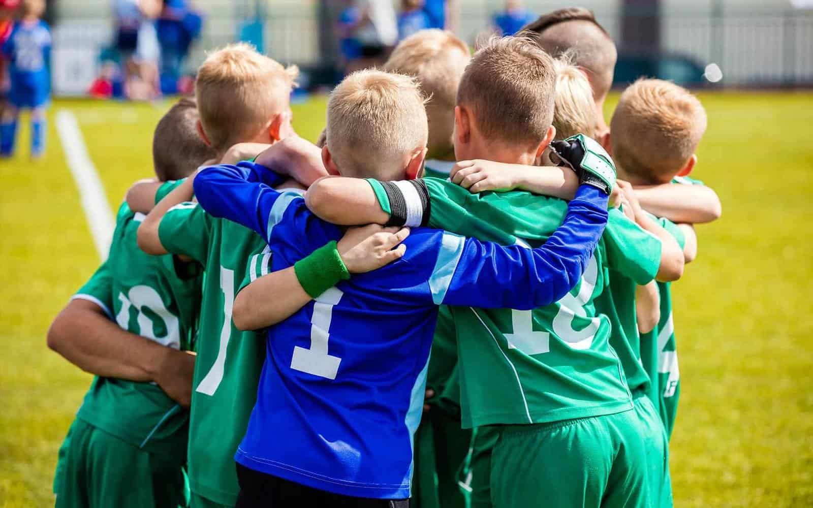 Youth soccer team huddled together during a match at Osaro Intl Sports Academy.
