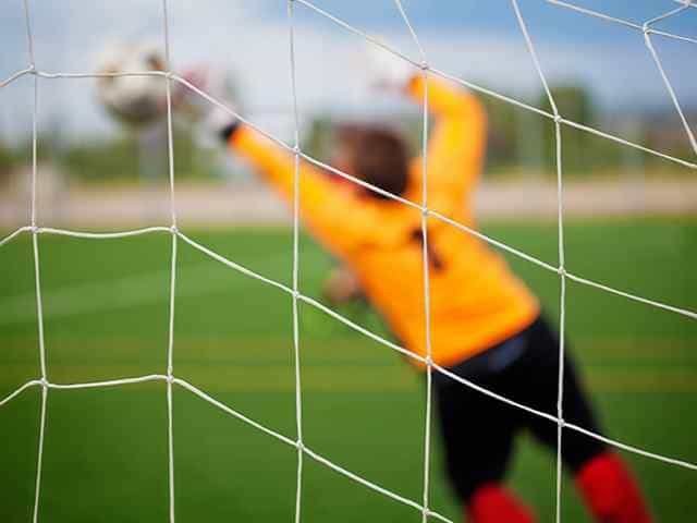 1. Young soccer goalkeeper training at Osaro Intl Sports Academy, focusing on goalkeeping skills.