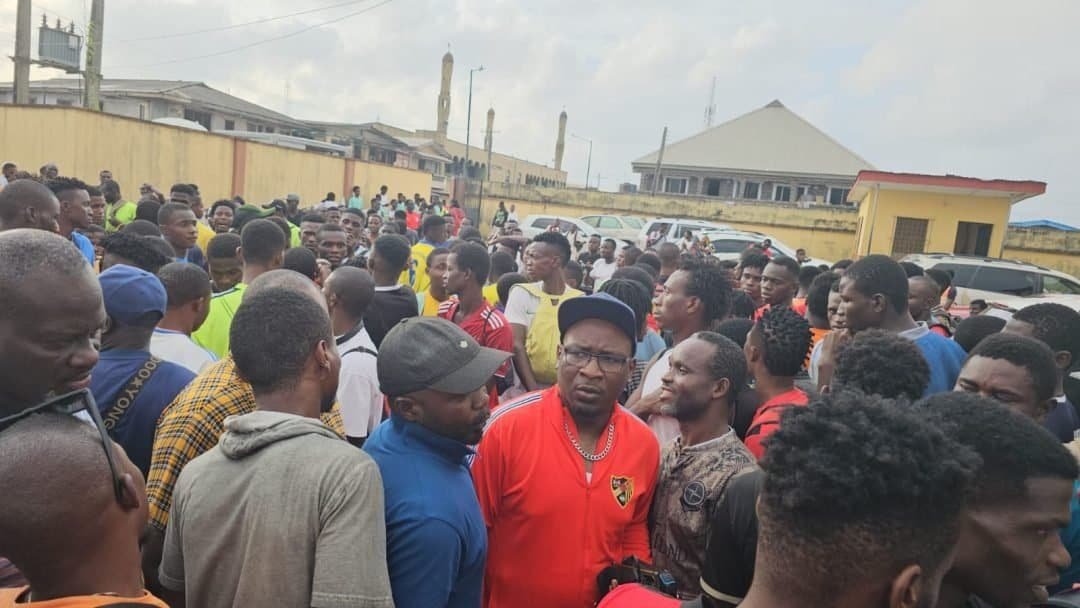 Osaro Intl Sports Academy youth sports event, diverse group of players and coaches at outdoor training session.