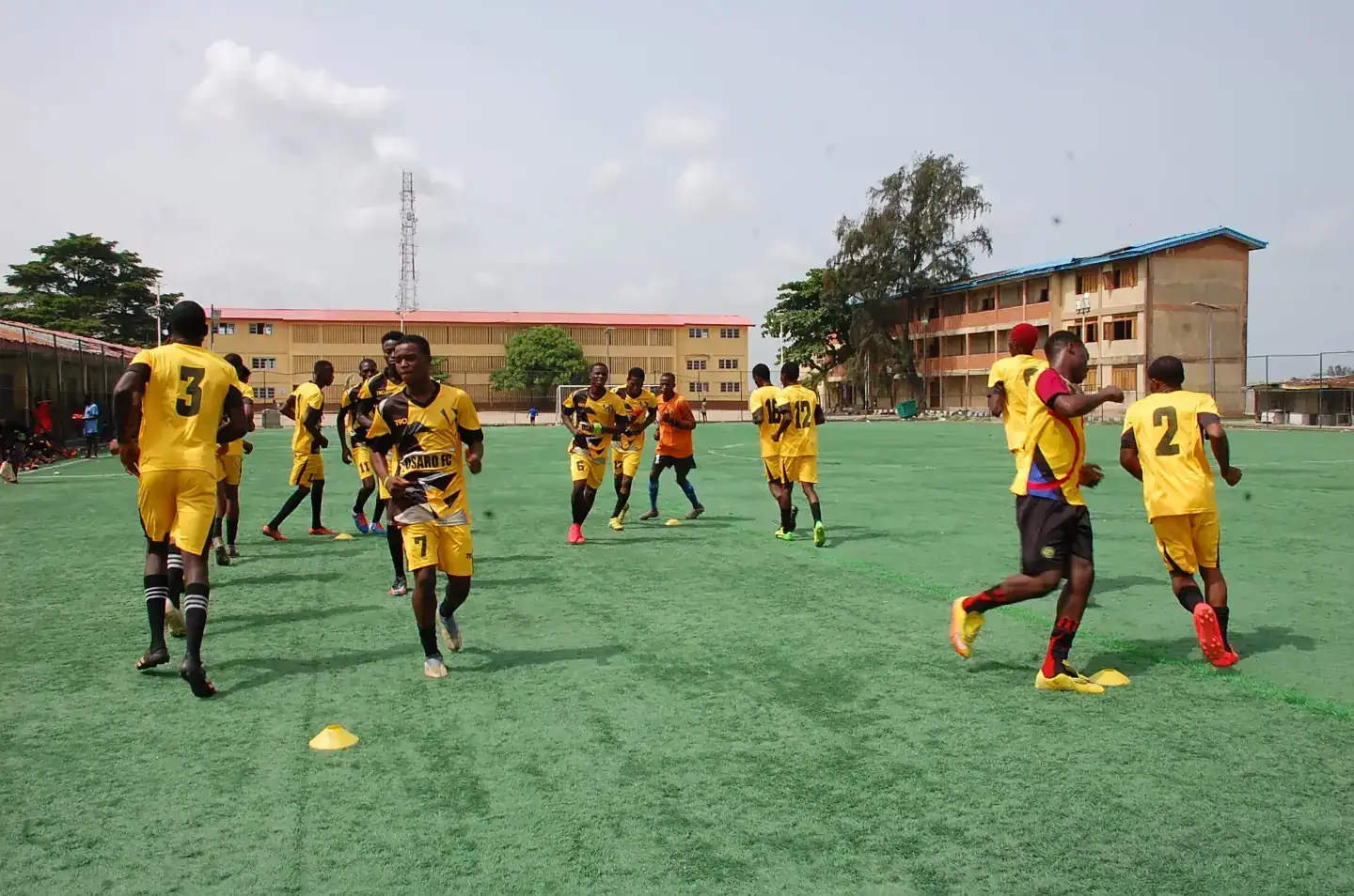 Youth soccer team training at Osaro Intl Sports Academy soccer field in Nigeria.