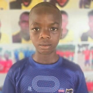 Young boy in Osaro Intl Sports Academy sportswear, focused and determined for athletic training.