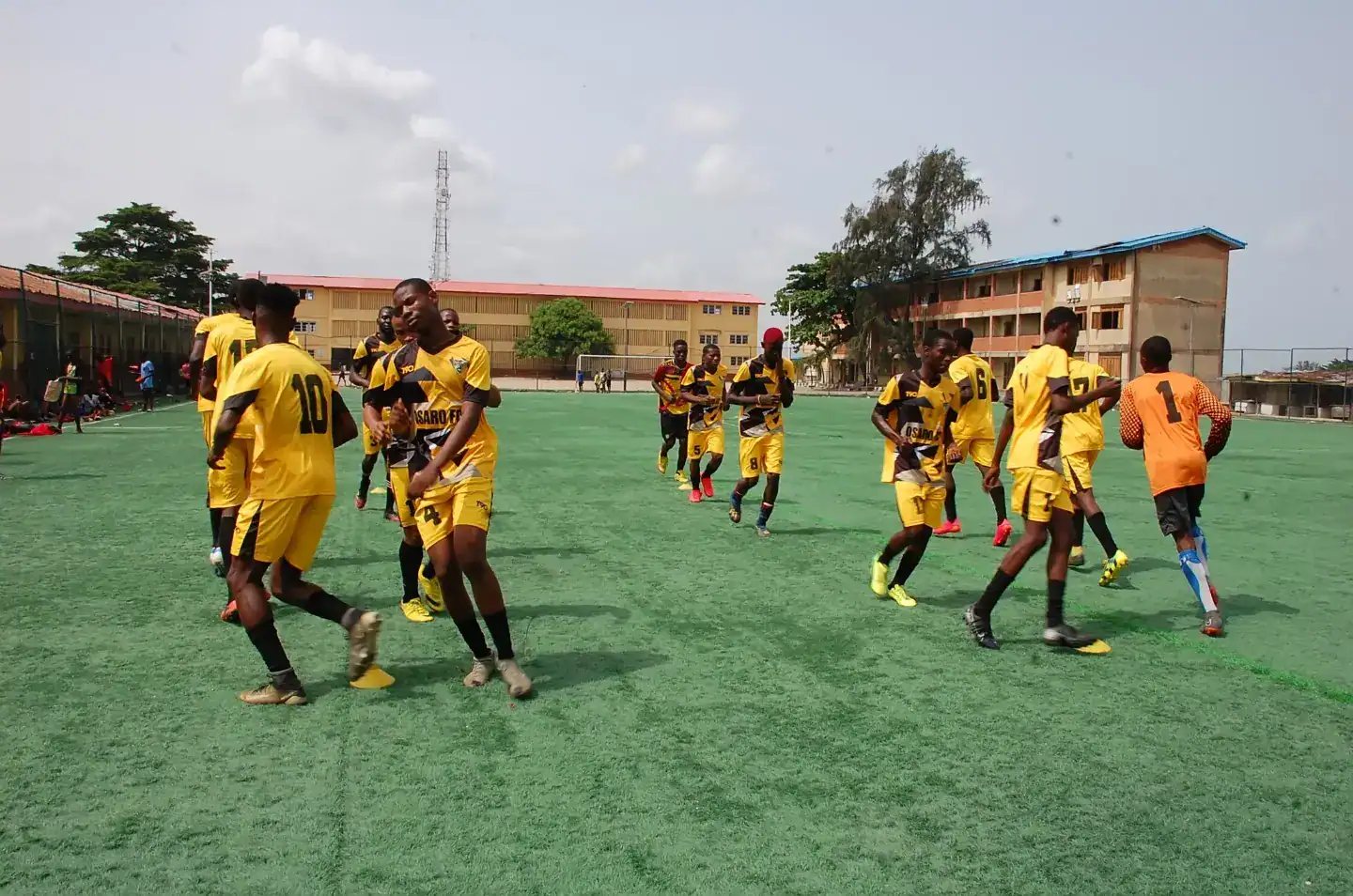 Junior soccer players practicing at Osaro International Sports Academy field for youth sports development and training programs.