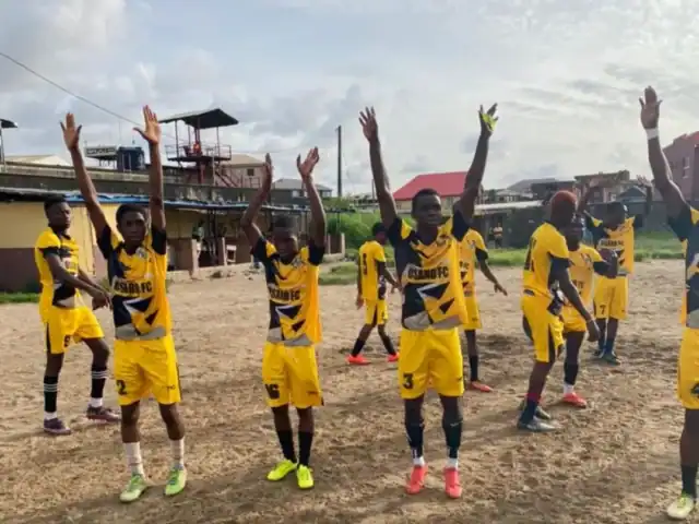 Youth soccer team at Osaro International Sports Academy, wearing yellow and black uniforms.