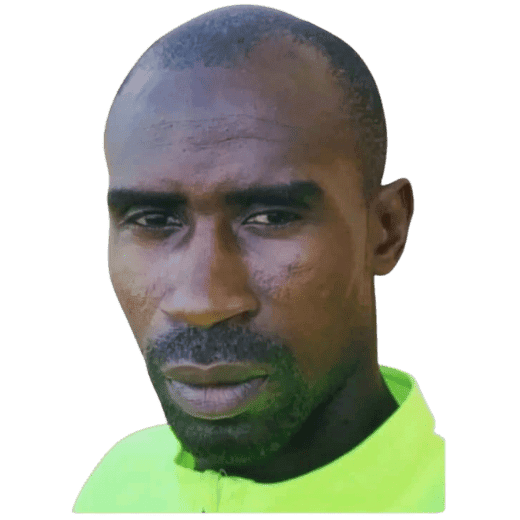 1. Man in neon sports jersey at Osaro Sports Academy soccer field.