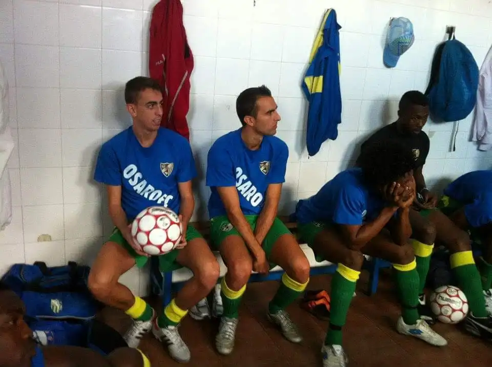 Osaro Intl Sports Academy boys soccer team preparing for match in locker room.