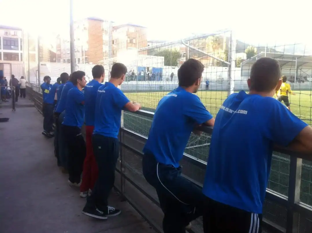 Young athletes watching soccer game at Osaro International Sports Academy.