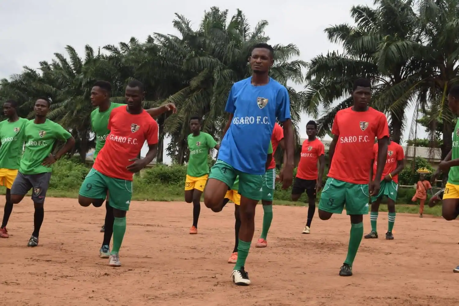 Youth soccer training at Osaro International Sports Academy in a tropical outdoor setting.