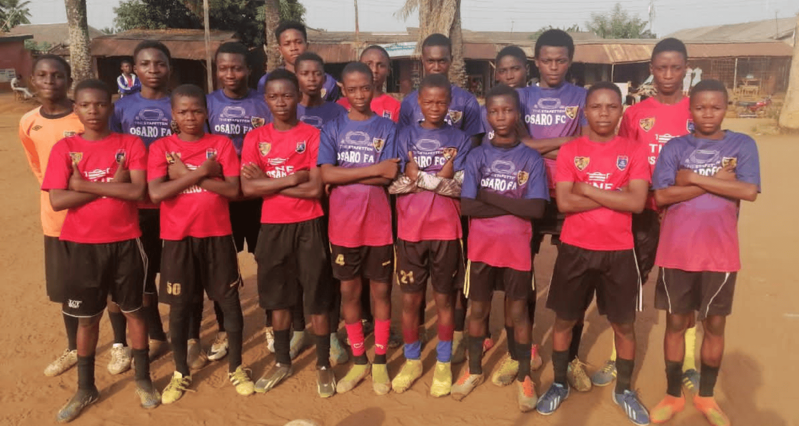 U20 soccer team posing on the field at Osaro Intl Sports Academy for youth football training.