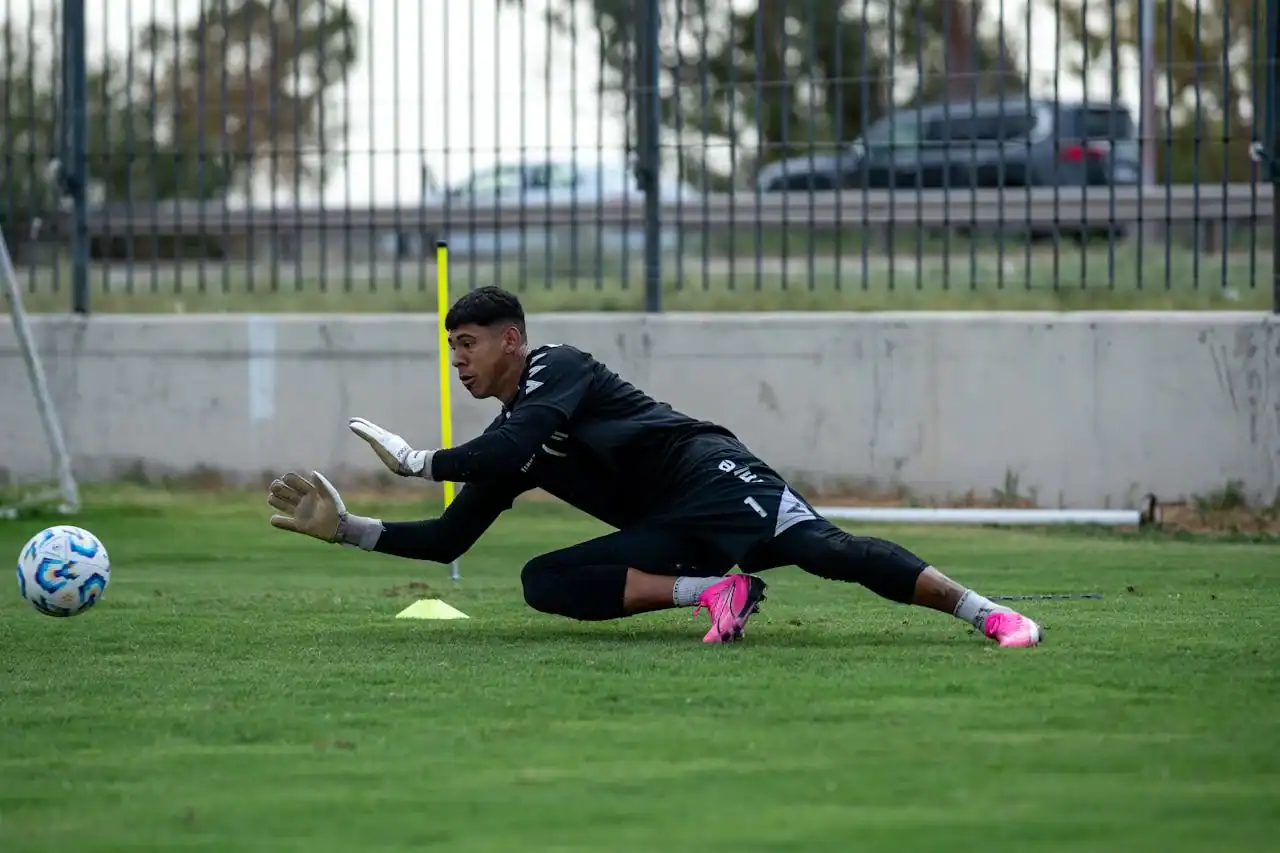 Position-Specific Coaching for Keepers Young soccer goalkeeper diving to save a ball during training at Osaro Intl Sports Academy.